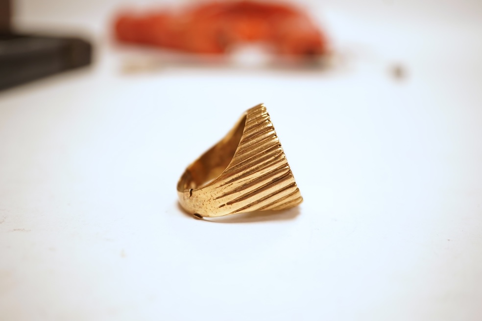 A sovereign ring, 1897 and later, set with a full sovereign dated 1897, to a fluted gold ring mount, size S (sizing band), ring mount stamped 9ct, gross weight 17 grams, Condition: typical surface wear